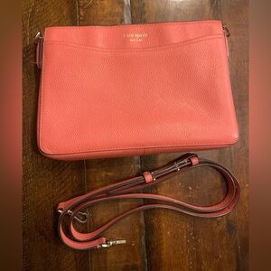 This is a Kate Spade salmon colored crossbody purse.